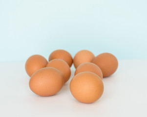  Fresh eggs in wicker basket  on wood table Prepare chicken eggs and egg whisk for cooking or bakery can use for background or wallpaper.