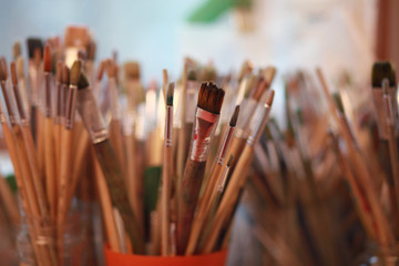 Fototapeta premium paint brushes in containers