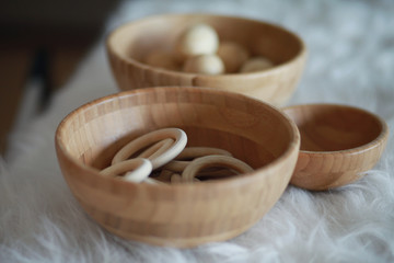 Bowl with wooden sensory materials for baby classroom