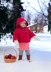 Two years old child in red coat at winter.