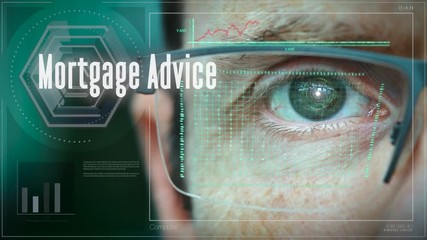 A close up of a businessman eye controlling a futuristic computer system with a Mortgage Advice Business concept.