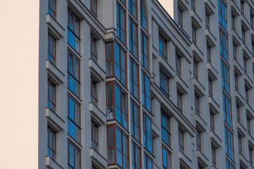 Facade of big modern building with apartments. Mortgage, accomodation, real estate construction...