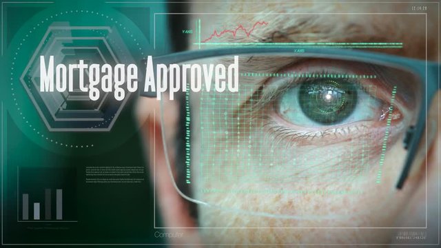 A close up of a businessman eye controlling a futuristic computer system with a Mortgage Approved Business concept.