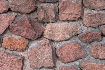 Wall made from red stone. Texture, background