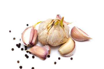 Fresh garlic  and pepper on white  board, isolated on white background.