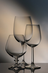 Glasses of different heights on a colored background.
