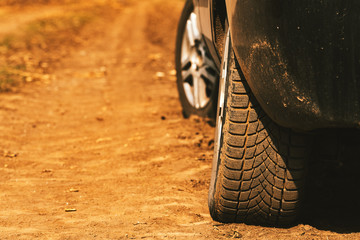 Close up of car tires on dirt country road