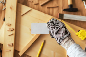 Carpenter holding blank mock up business card