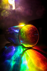 Tumbler tipped over refracting and dispersing light like a prism