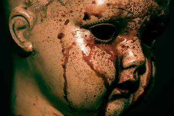 Creepy bloody doll in the dark