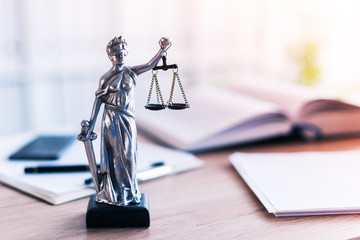 Lady Justice statue in law firm office - obrazy, fototapety, plakaty
