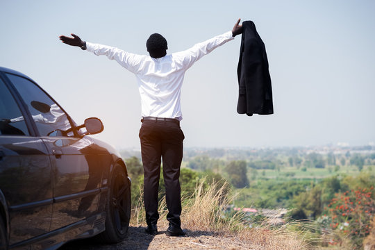 Freedom African Businessman Take Off Suit And Standing On Top Of Mountain With Car