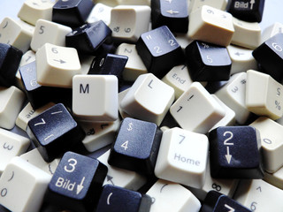 White computer keyboard keys, mostly numeric with ML (Machine learning) buttons at the front. Concept of unstructured big data that need to be sorted ready to be consumed by ML or deep learning.