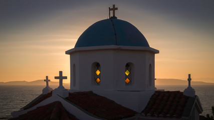 Sunset above the hills of the Mani peninsula and behind the church of Agia Paraskevi on the Peloponnese in Greece.