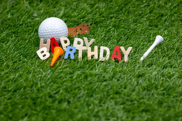 Happy Birthday to golfer is on green grass with golf ball and teee