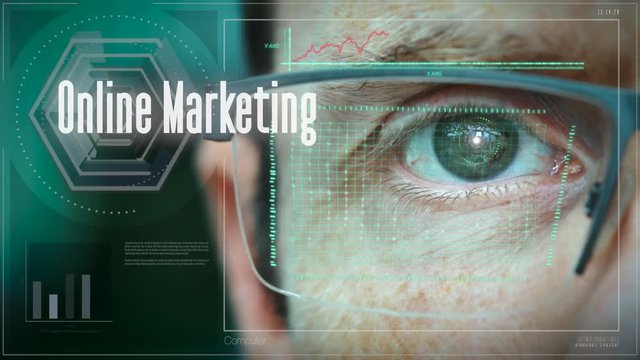 A close up of a businessman eye controlling a futuristic computer system with a Online Marketing Business concept.