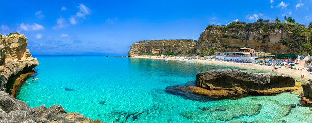 Beautiful turquoise sea and great beaches of Calabria. Oasi beach near Tropea town - obrazy, fototapety, plakaty