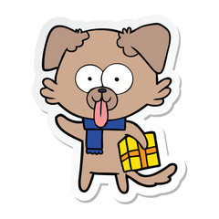 Fototapeta premium sticker of a cartoon dog with christmas present