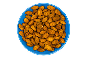 Almond nuts in blue plate on white background. Almond nut flat lay. Almond heap top view. Tasty healthy snack