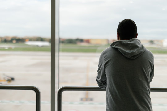 Young man is waiting at the airport for his flight