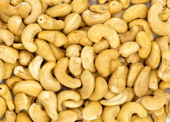 Cashew nuts background, top view photo. Tasty healthy snack. Scattered nut on table. Organic food rustic banner template