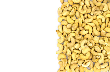 Cashew nut half on white background, top view photo with text place. Scattered nut. Organic food rustic banner template