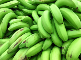Background of fresh green plantain bananas closeup © peppystudio