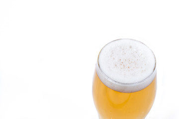 A glass of frothy bubbly beer isolated in white. 