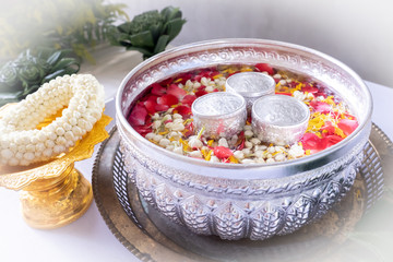 Jasmine and roses in blow water for blessing ceremony of adults, Songkran festival in Thailand.