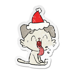 distressed sticker cartoon of a panting dog wearing santa hat
