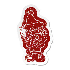 man with beard sticking out tongue wearing santa hat