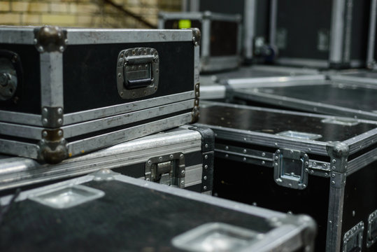 Stage equipment behind the scenes. Concert activity. Cases for transportation of equipment. Boxes on the wheels.