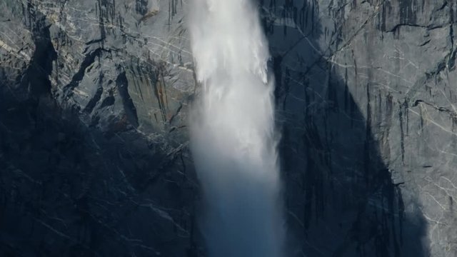 Water stream falling from a steep cliff from the melting glacier of the Queulat National Park in Patagonia, Chile