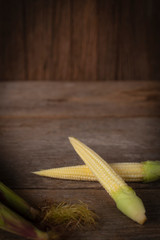 Fresh ripe Baby corn on the wood table background