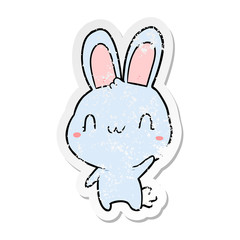 distressed sticker of a cartoon rabbit waving