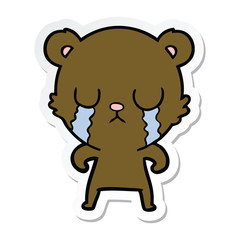 sticker of a crying cartoon bear