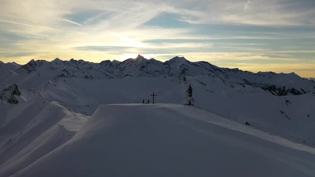 Two ski mountaineers standing on top of the mountain summit called Rei&szlig;rachkopf in the valley of Rauris for sunset mood.