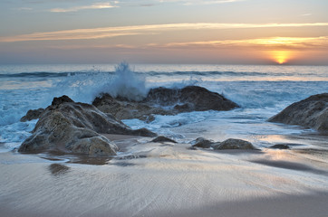 Waves and sunset in Salgados beach. Albufeira, Portugal