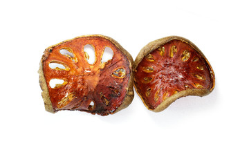 Image of dry bael fruit on white background. Food.