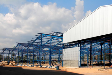 Structure of steel roof frame for building construction on sky background