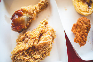 Crispy fried chicken junk food in the paper box of a franchise cafe.