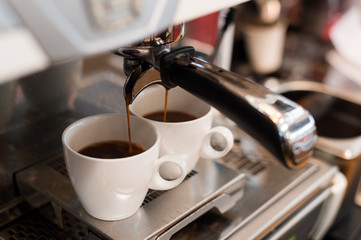 hot coffee in white cup on coffee maker