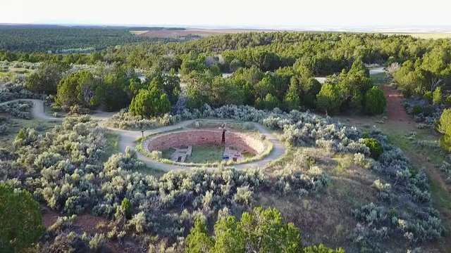 Tilt reveal drone shot over the Lowry Pueblo ruins and the surrounding landscape.