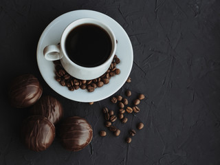Chocolate cakes and cup of coffee on dark background