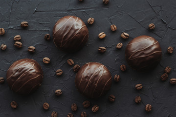 Chocolate cakes and coffee beans on a black background