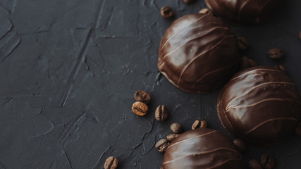 Chocolate cakes and coffee beans on a black background