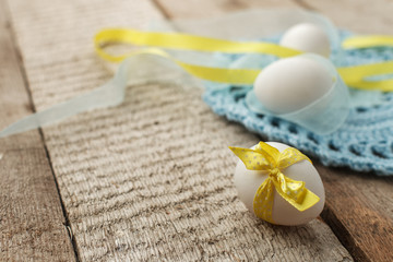 Easter holiday card with variety of easter eggs on vintage wooden rustic background with copy space