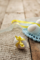 Easter holiday card with variety of easter eggs on vintage wooden rustic background with copy space