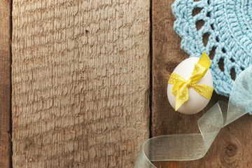 Rustic Easter background with chicken egg on old vintage wooden board with blank space for text