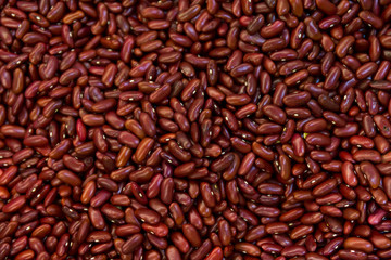 Red kidney bean texture background. Also called Rajma or Mexican Bean. A large, kidney-shaped bean with a subtle sweet flavor and soft texture that keep their shape during cooking.